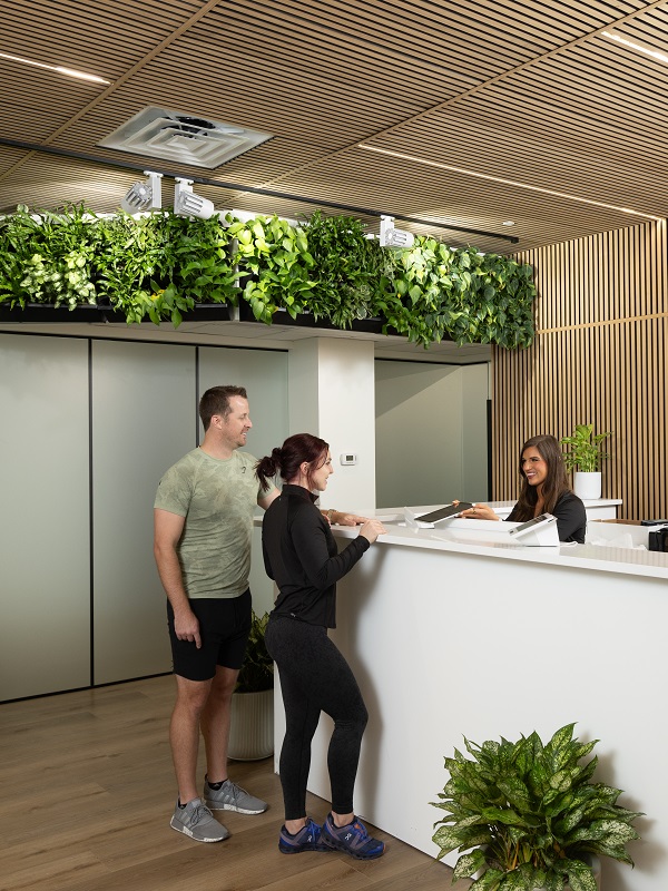 Fitness and Longevity Center Couple Signing In At Front Desk