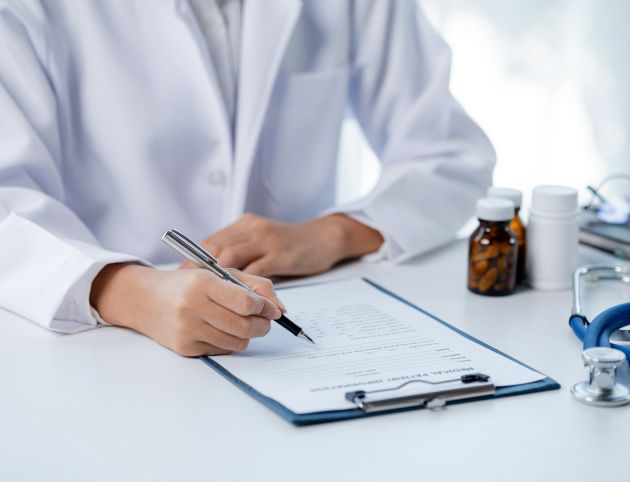 Doctors looking at patient's diagnostic documentation in the hospital's medical room.